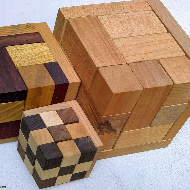 Rhoma and other rhombic blocks packing puzzles